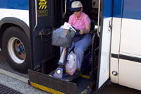 person in wheelchair loading a bus